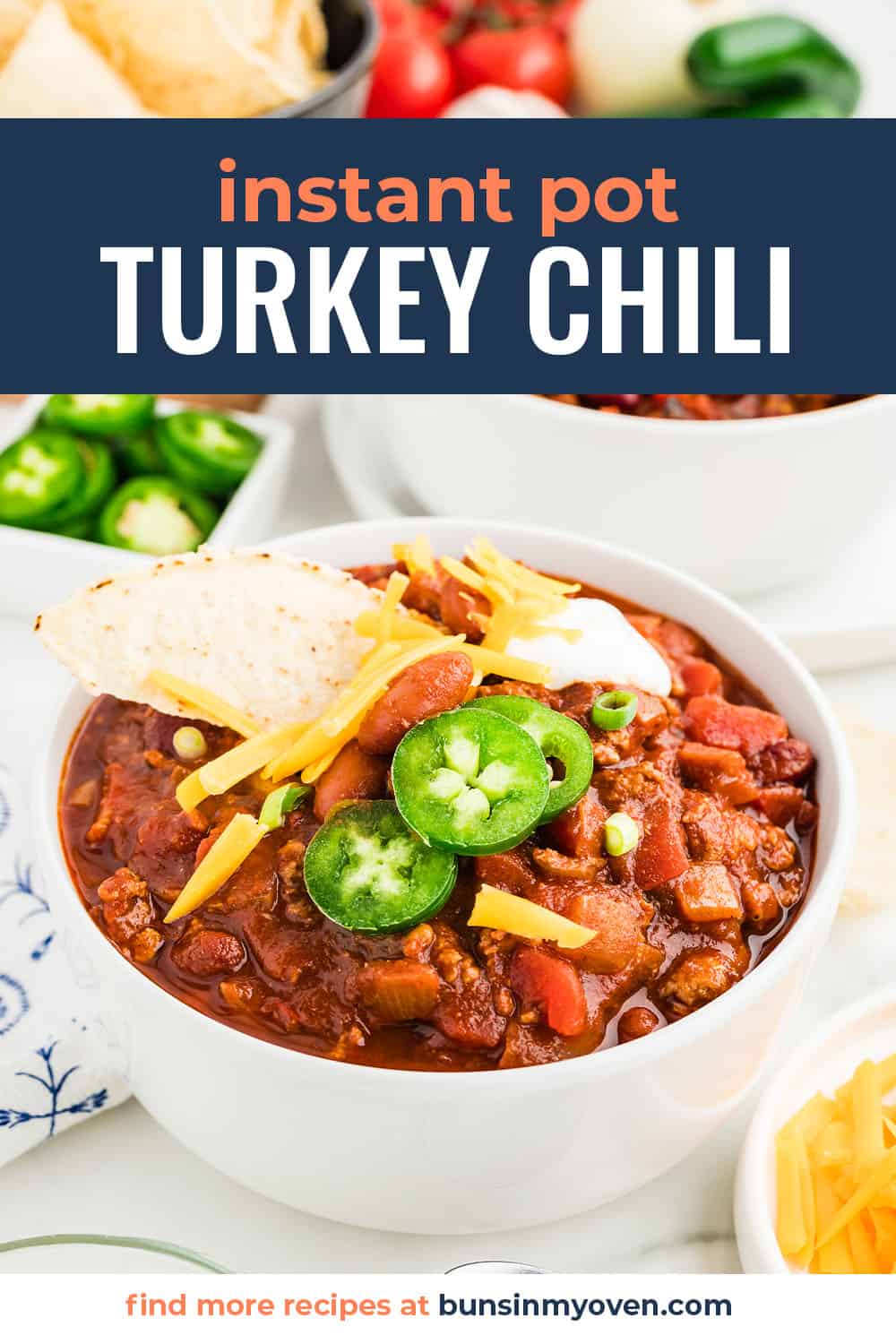 Bowl full of Instant Pot turkey chili recipe topped with jalapenos and cheese.