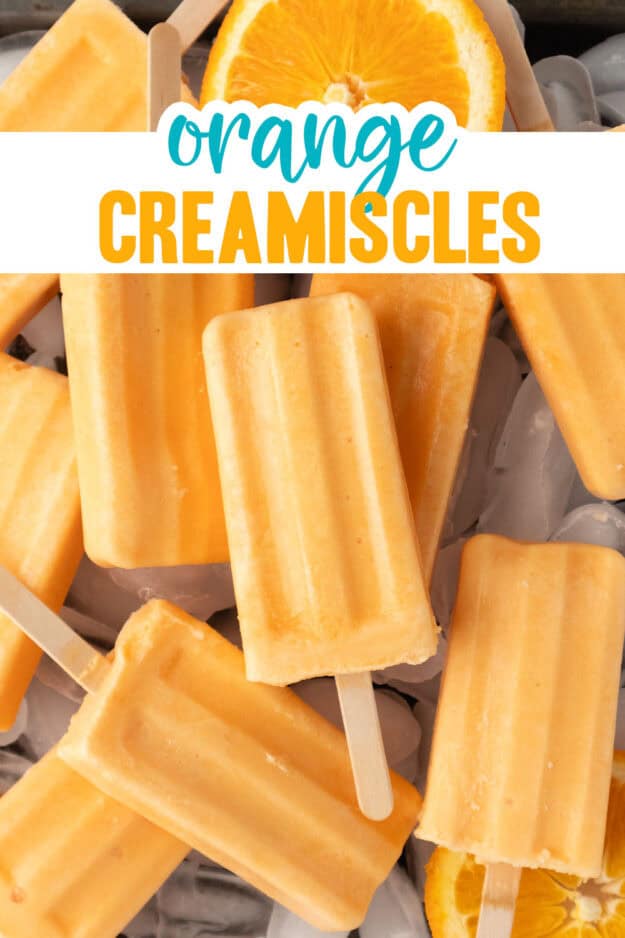 Orange creamsicles on tray of ice.