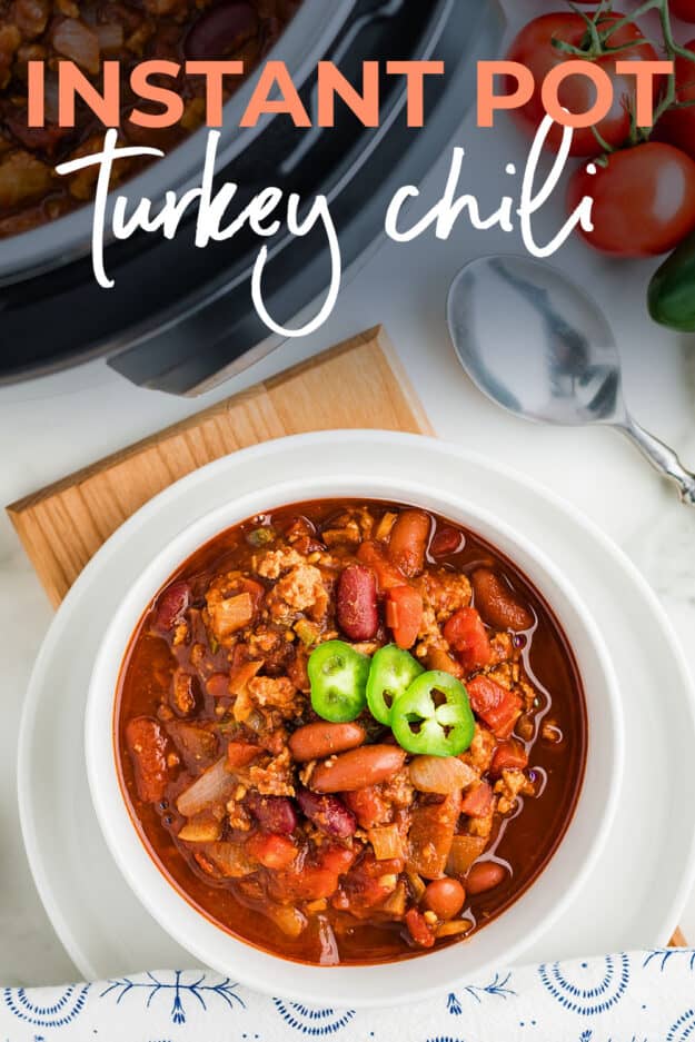 Overhead view of turkey chili in white bowl next to Instant Pot.