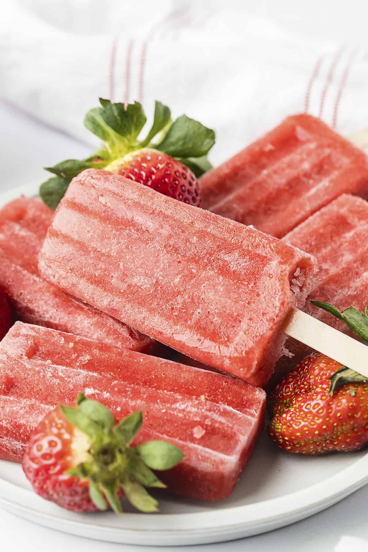 Popsicles piled on plate.