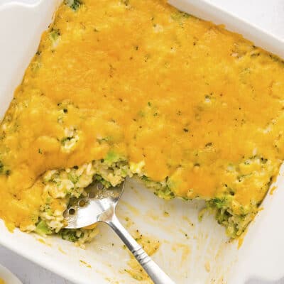 White baking dish full of broccoli casserole with rice.