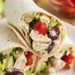 Stack of Greek chicken wraps.