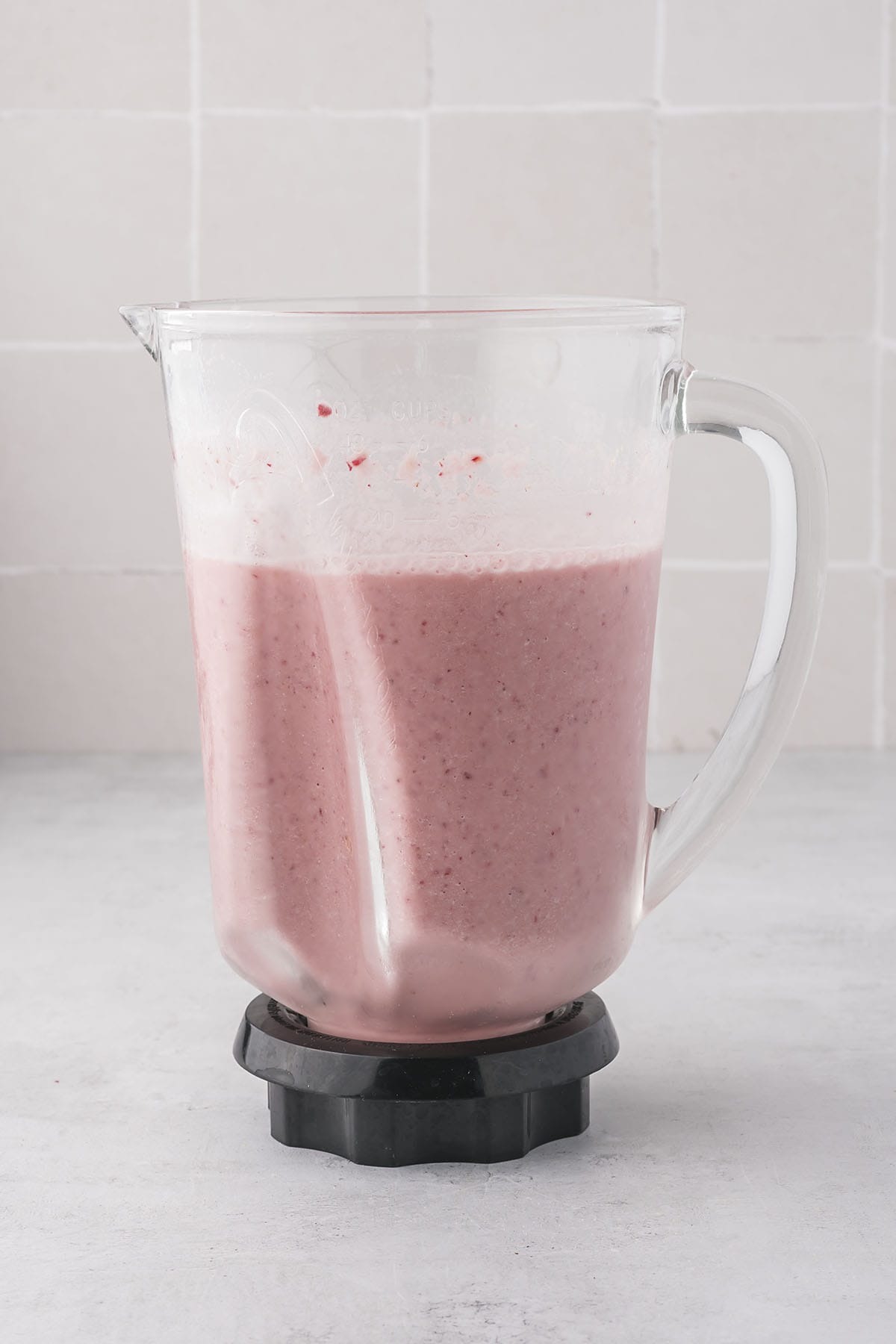 Strawberry pineapple smoothie in blender jar.