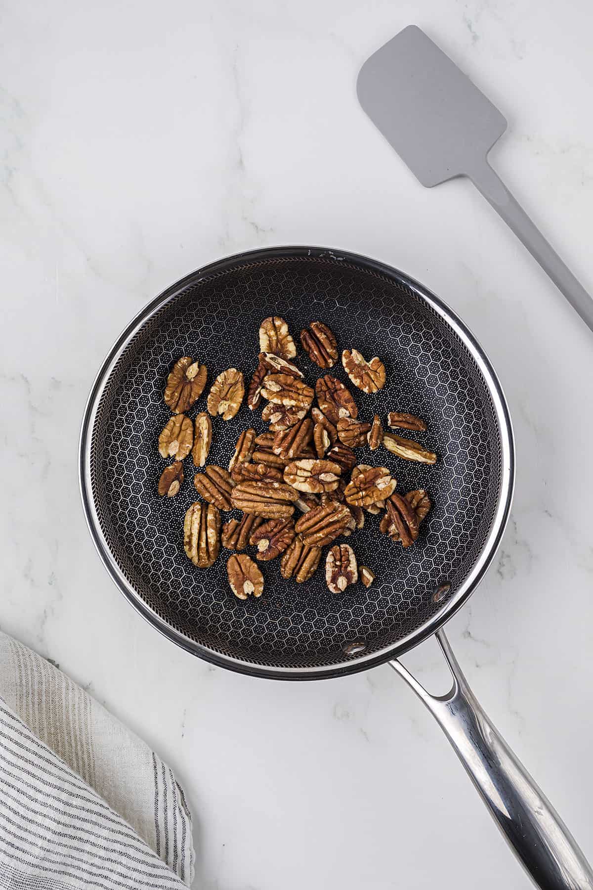 Pecans toasting in skillet.