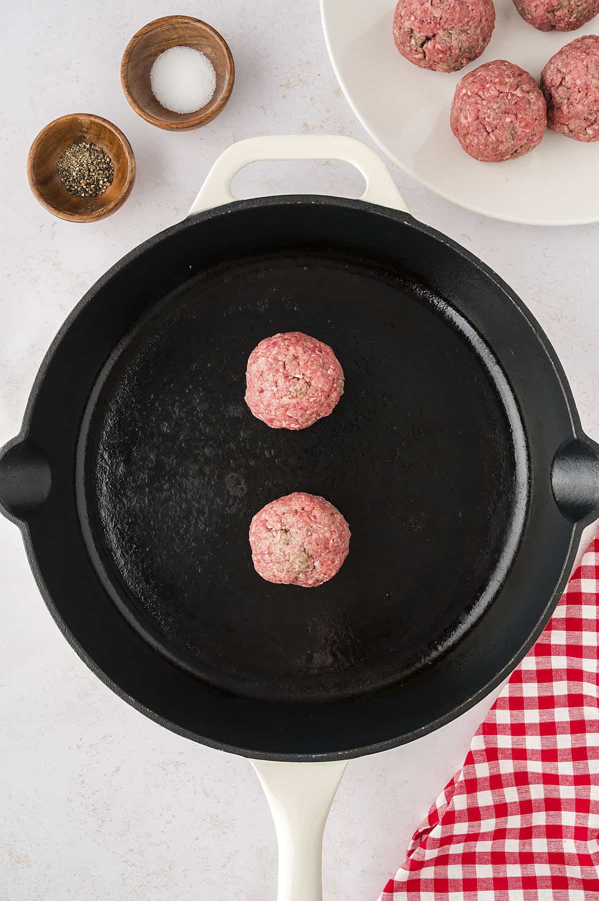 Balls of beef in skillet.