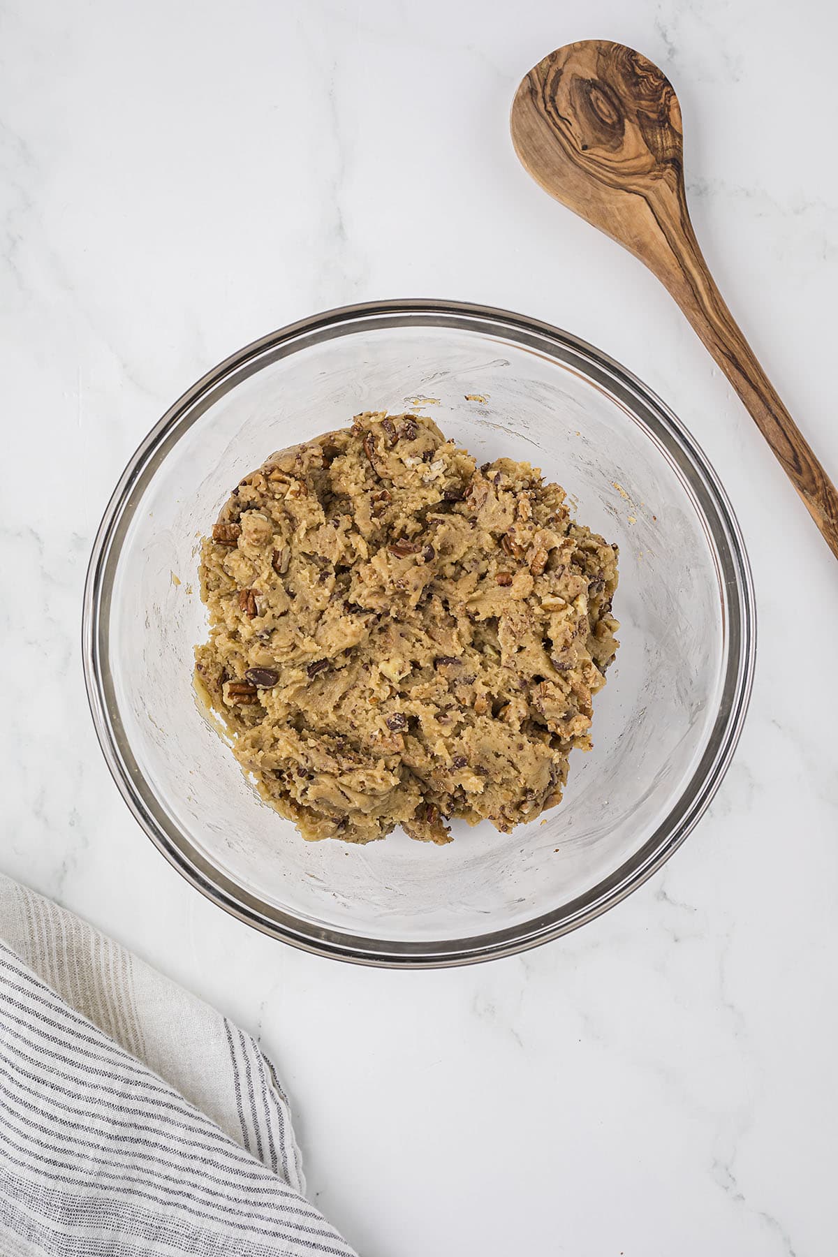Bowl of cookie dough filled with pecans and toffee.