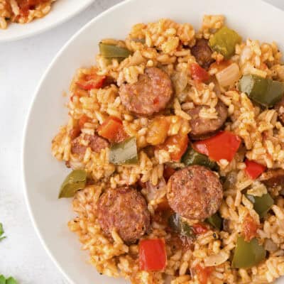 Cajun sausage and rice on white plate.