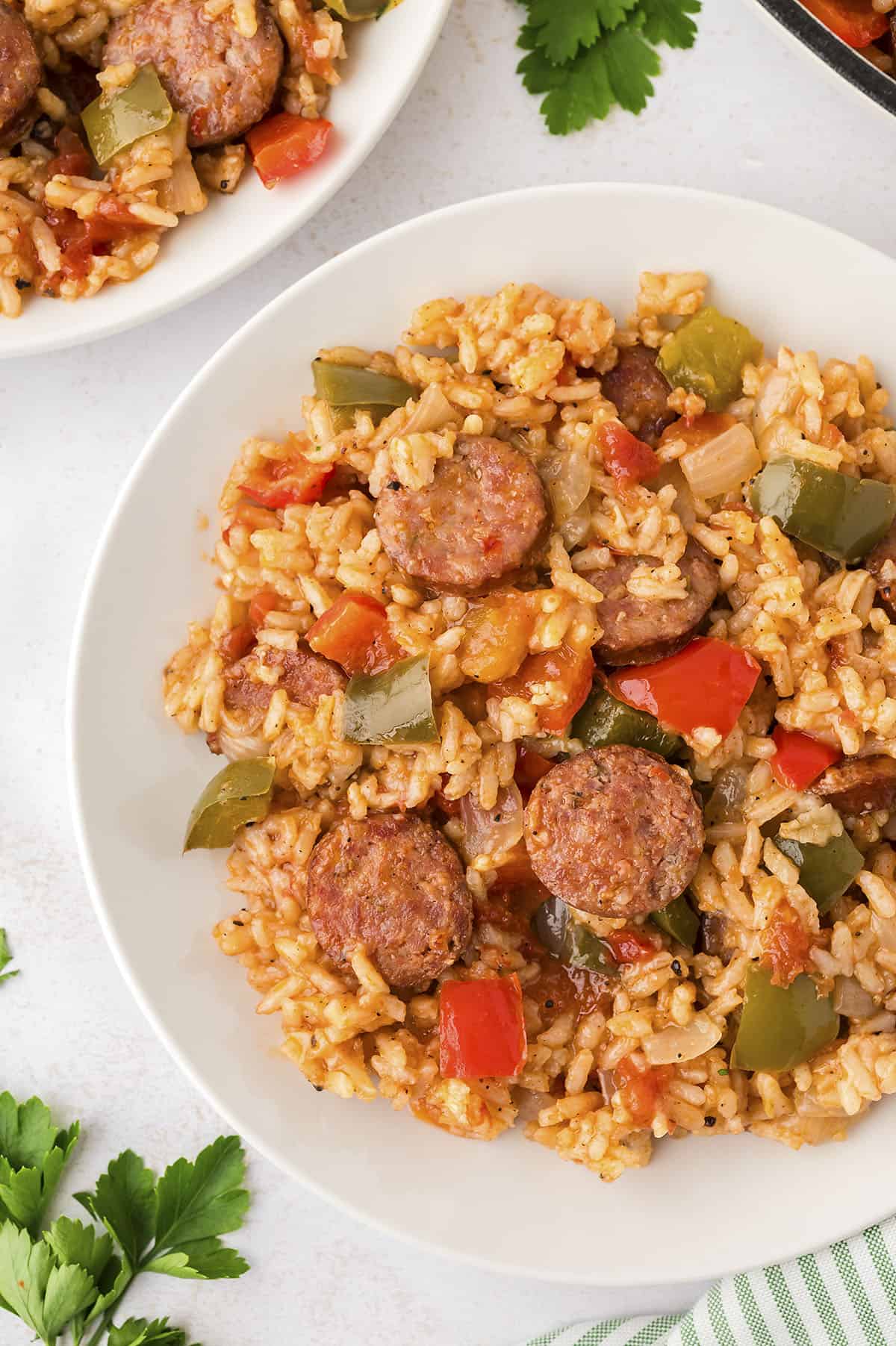 Cajun sausage and rice on white plate.