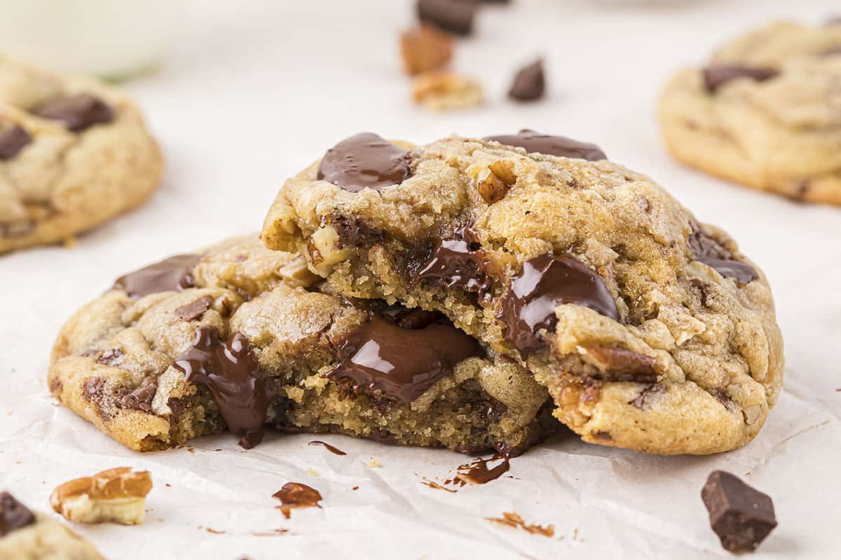 Toffee chocolate chip cookies split open and piled on counter.