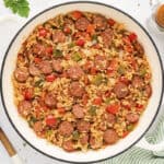 Skillet full of sausage, rice, and peppers.