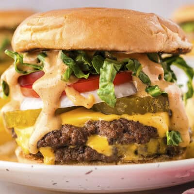 Smashburger on white plate with fries.