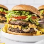 PImento cheese smashburgers on plates.