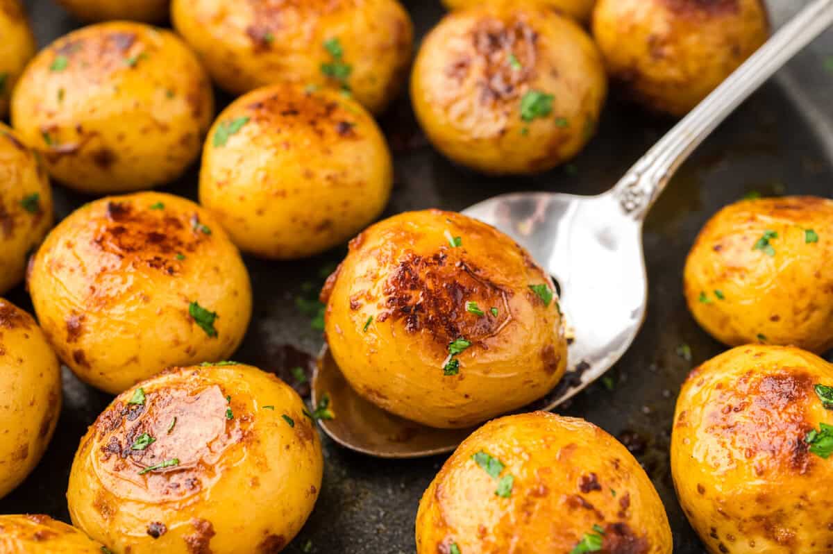 Browned baby yellow potatoes in skillet.