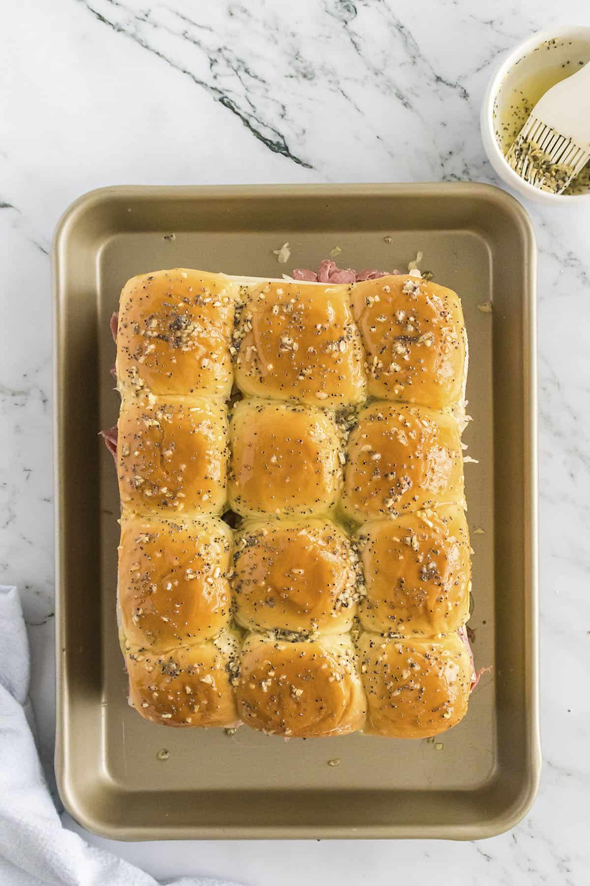 Reuben sliders on baking sheet.