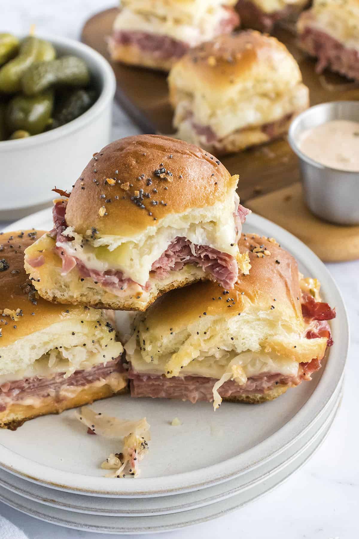 Stack of reuben sliders on plate.