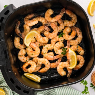 Air fryer cajun shrimp in air fryer basket.
