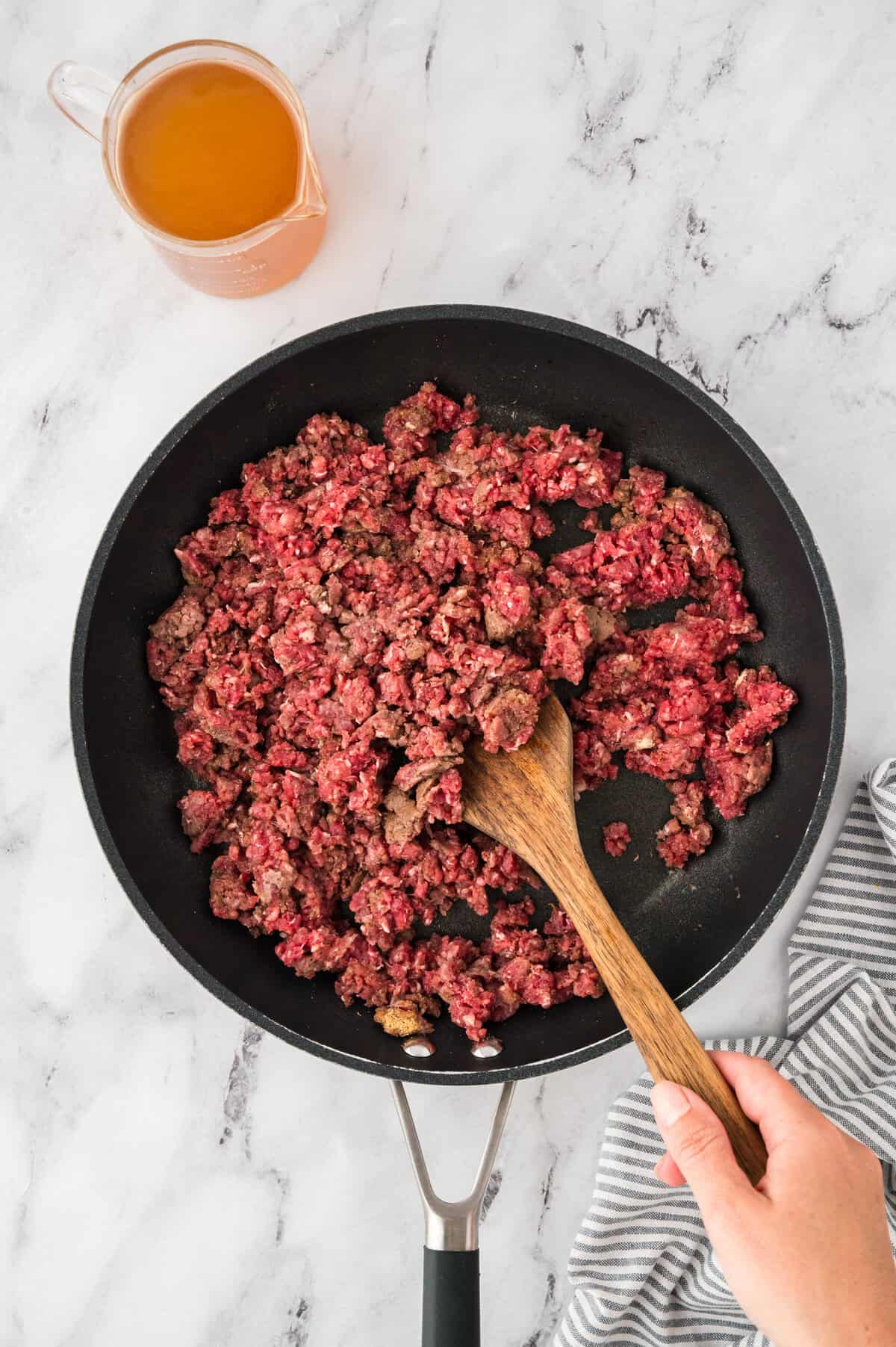 Ground beef being browned in skillet.