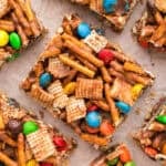 Sliced snack bar featuring pretzels, cereal, and chocolate.