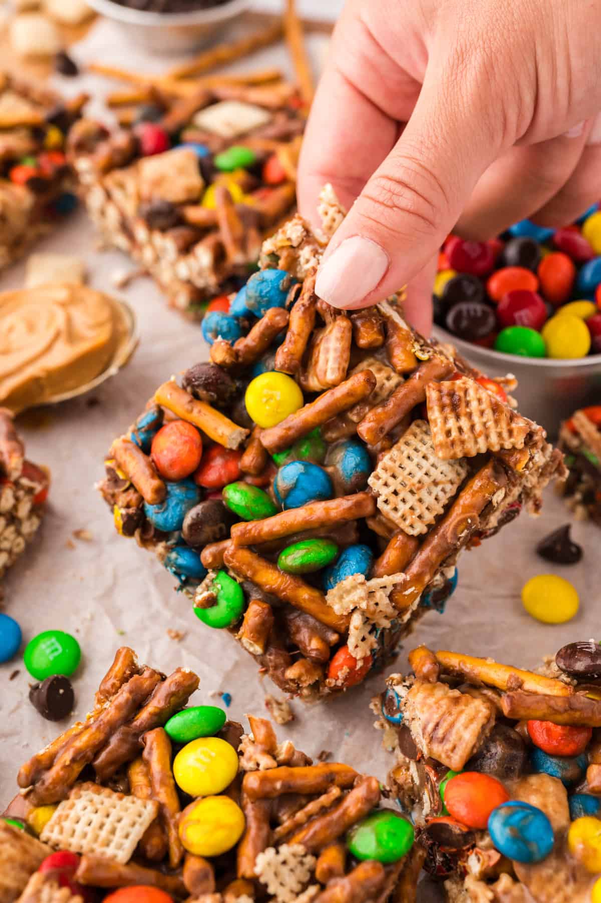 Hand grabbing a snack mix bar.
