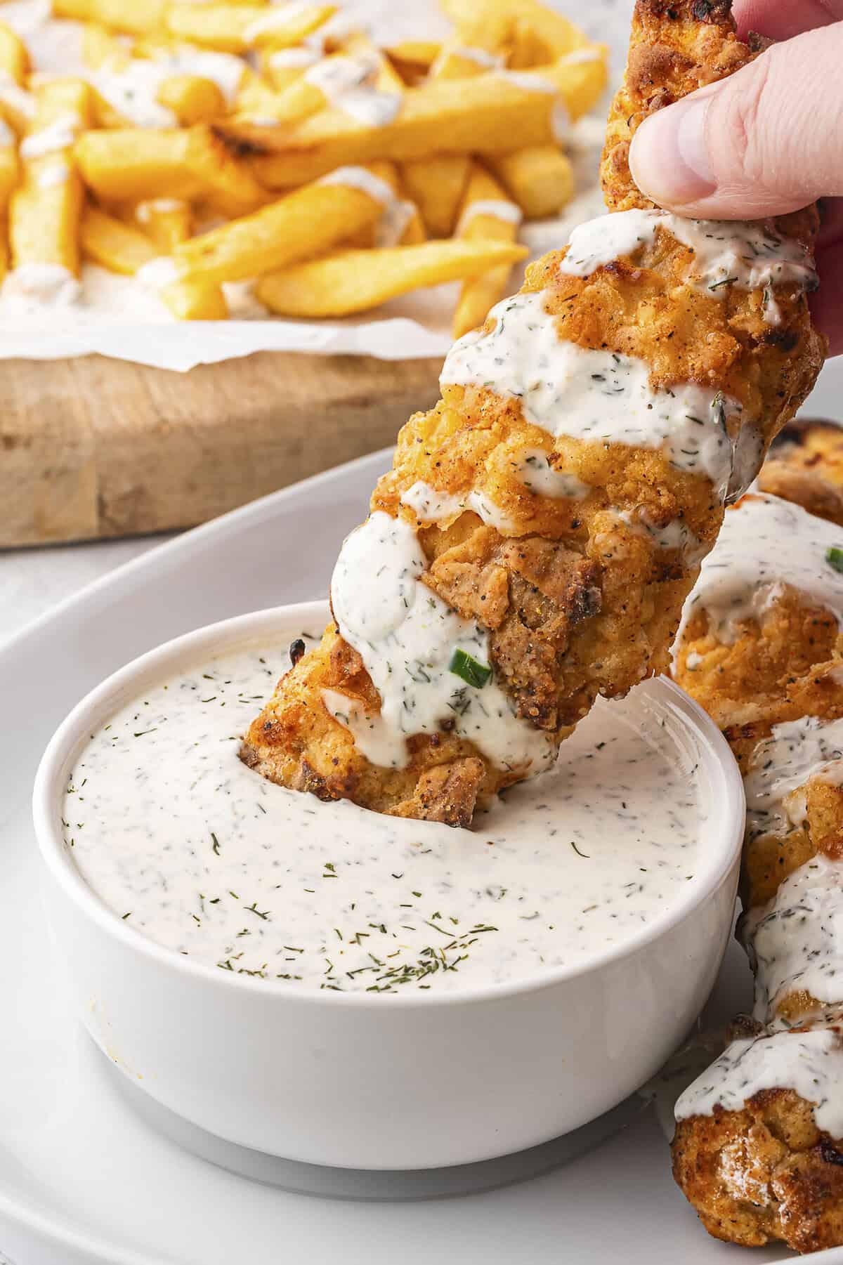 Crispy buttermilk chicken tenders dipped in ranch.