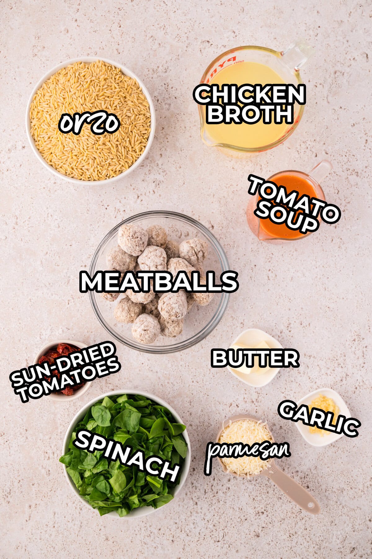 Tomato baked orzo ingredients in small dishes on counter.