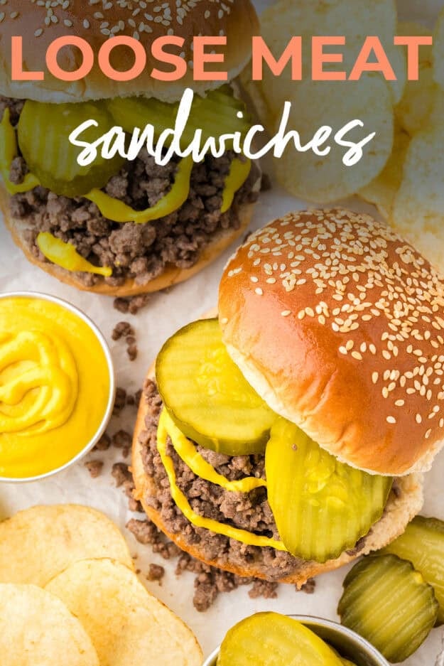 Loose meat sandwich topped with pickles and mustard.