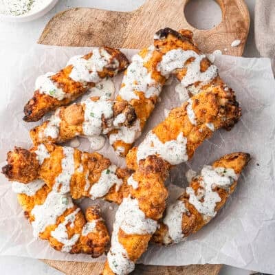 Crispy buttermilk chicken tenders drizzled with homemade ranch dressing.