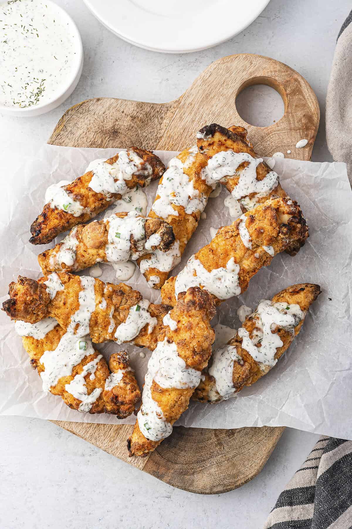 Crispy buttermilk chicken tenders drizzled with homemade ranch dressing.