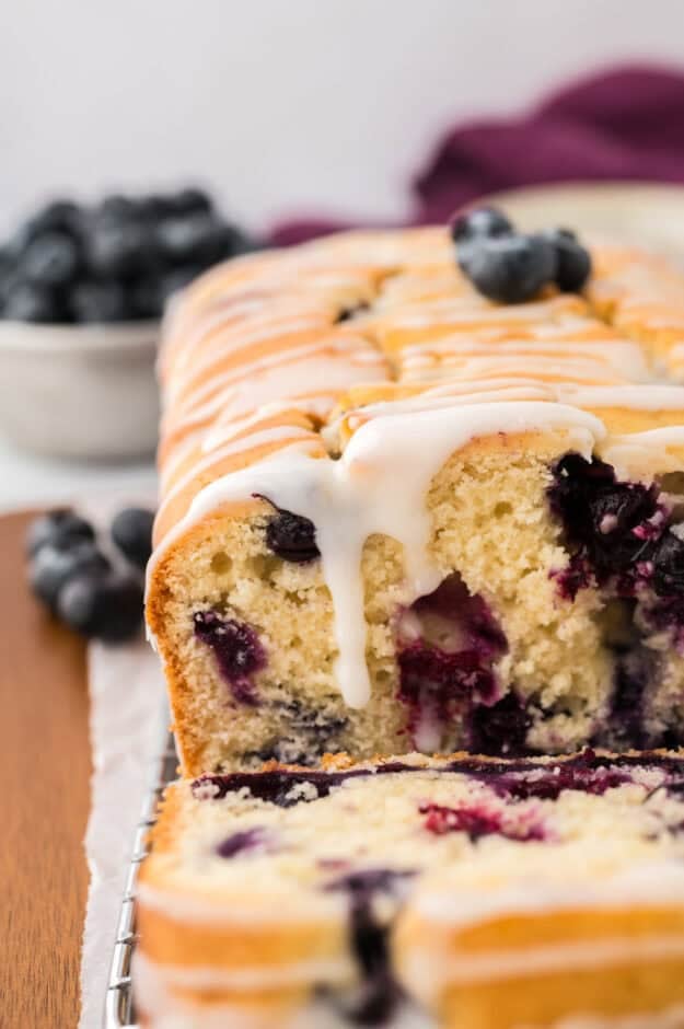 Blueberry muffin bread with glaze dripping down.
