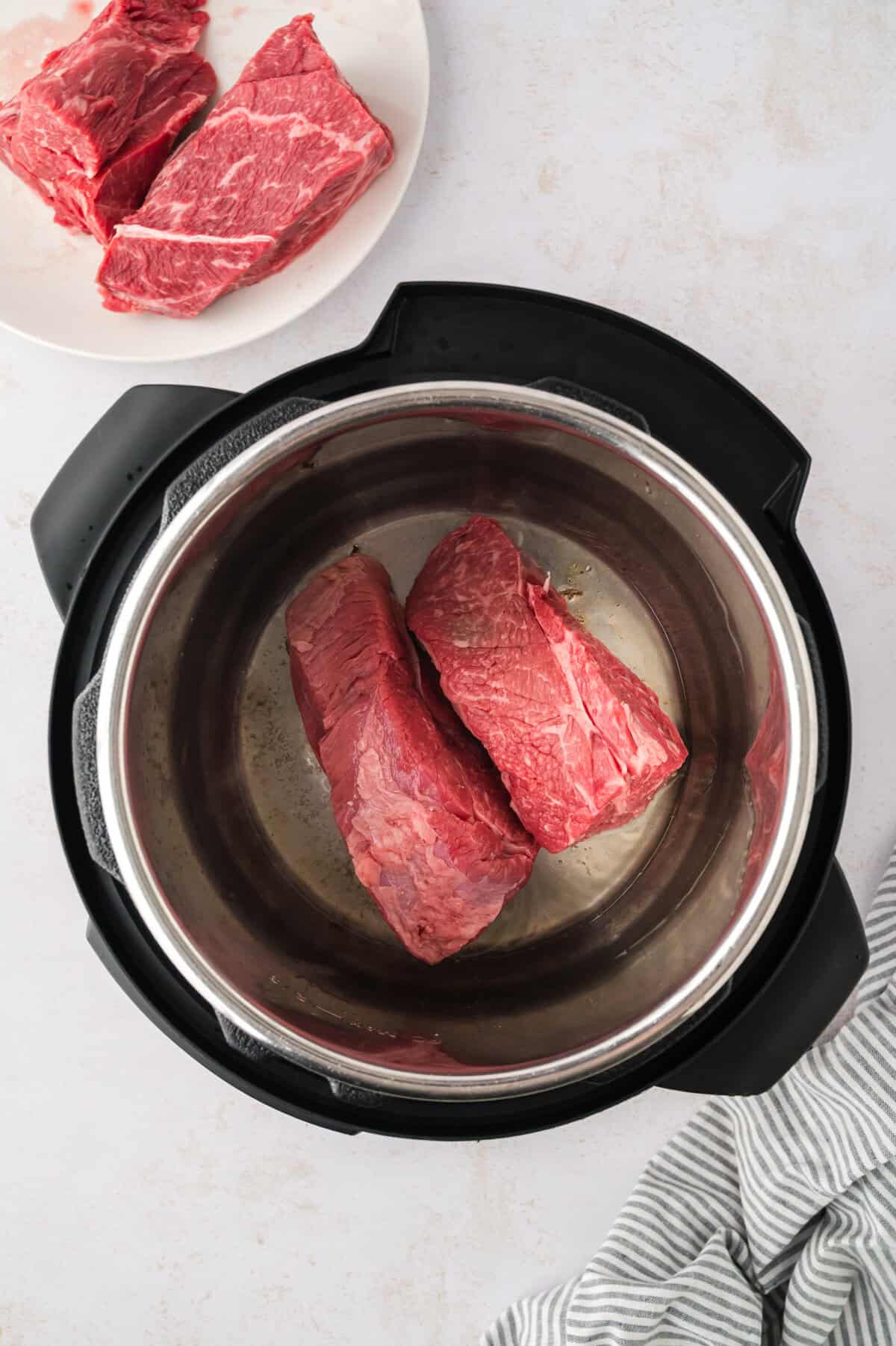 Chuck roast being seared in Instant Pot.