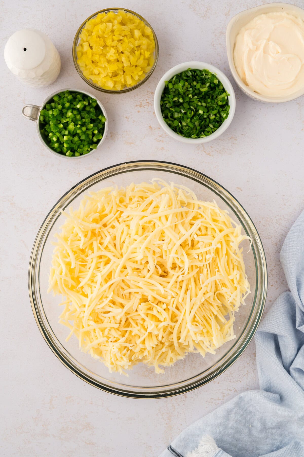 Shredded swiss cheese in mixing bowl.