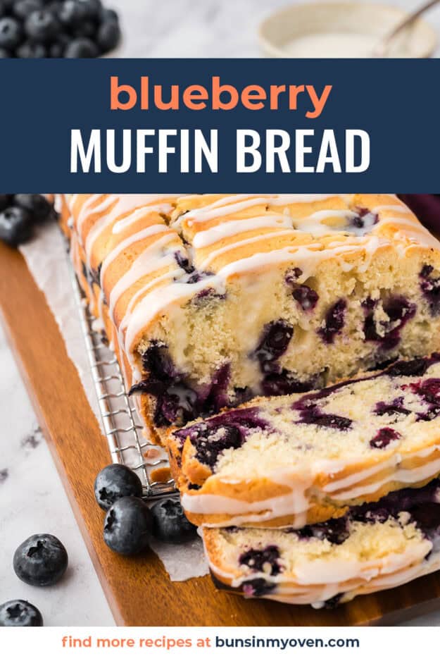 Loaf of blueberry bread with a glaze on cooling rack.