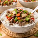 Beef and pepper rice bowls on small hot pad.