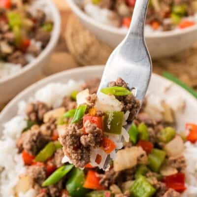 Beef and peppers in bowl of rice.