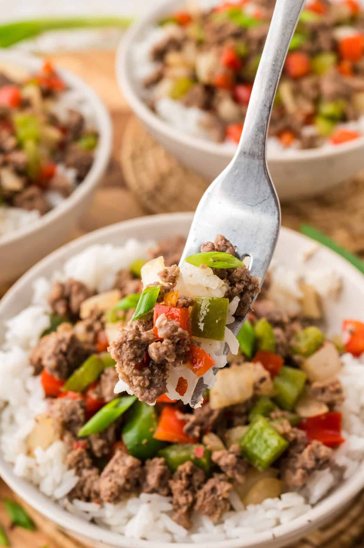 Beef and peppers in bowl of rice.