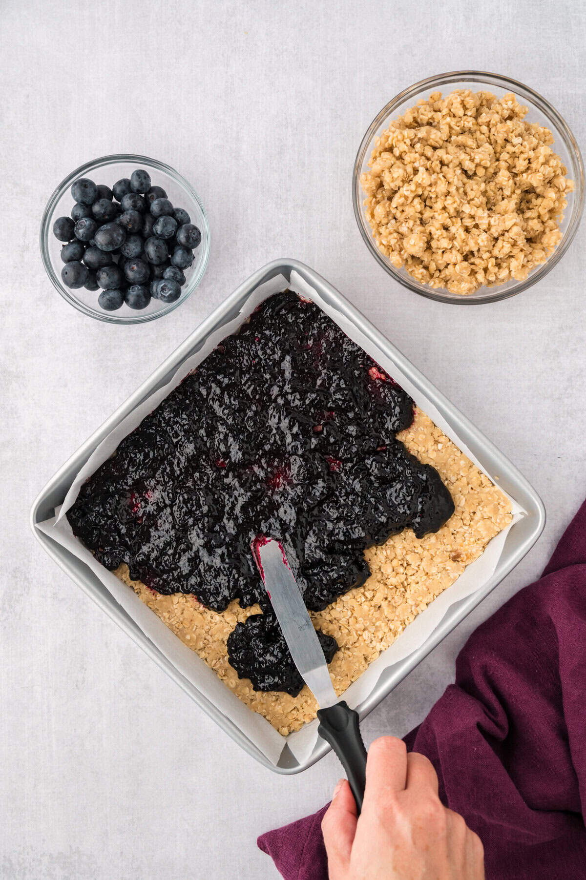 Blueberry preserves spread over crust.
