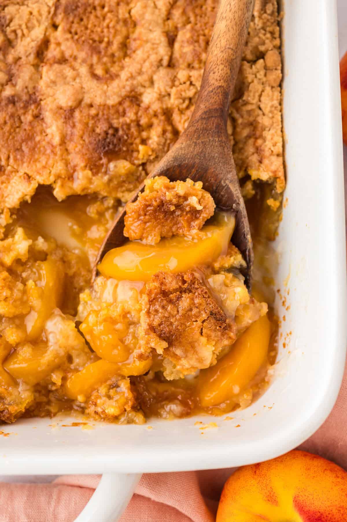 Peach dump cake in white 9x13 bakign dish.