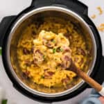 Instant pot mac and cheese on wooden spoon.