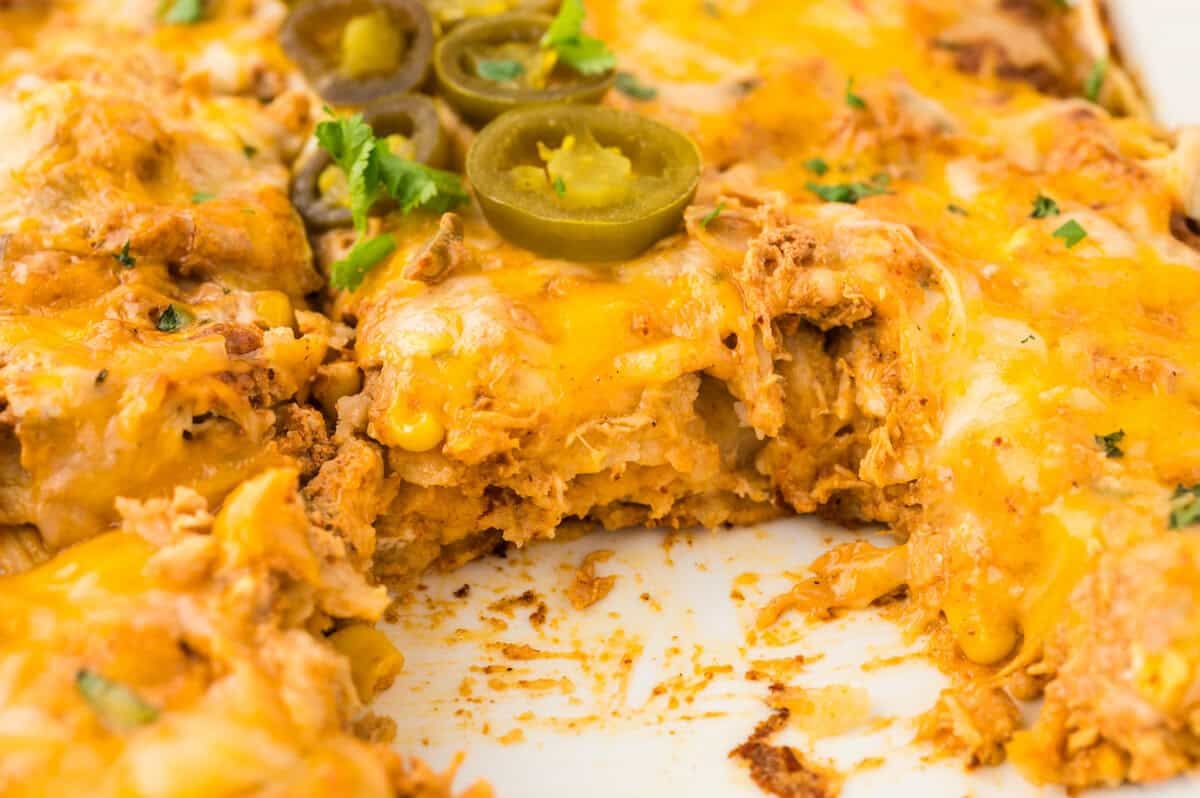 Sour cream chicken enchilada casserole in baking dish.