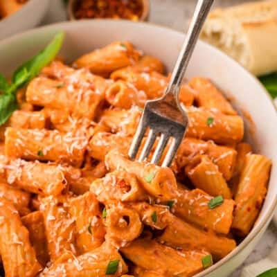 Not too spicy rigatoni in bowl with fork.