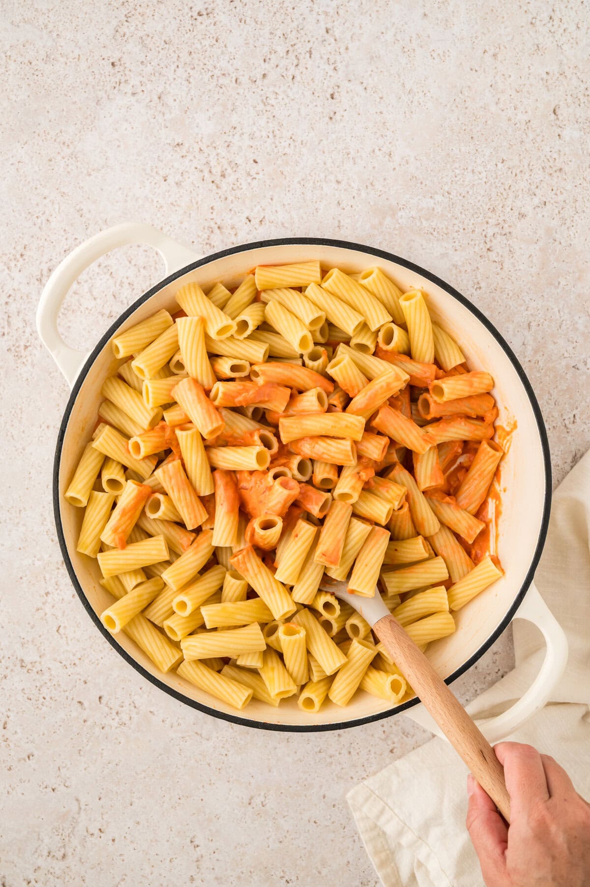 Pasta stirred into tomato sauce.