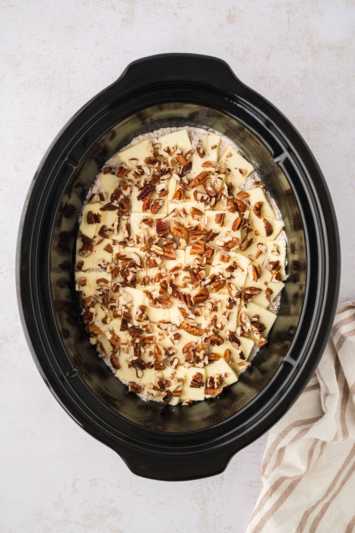 Butter and pecans over cake mix.