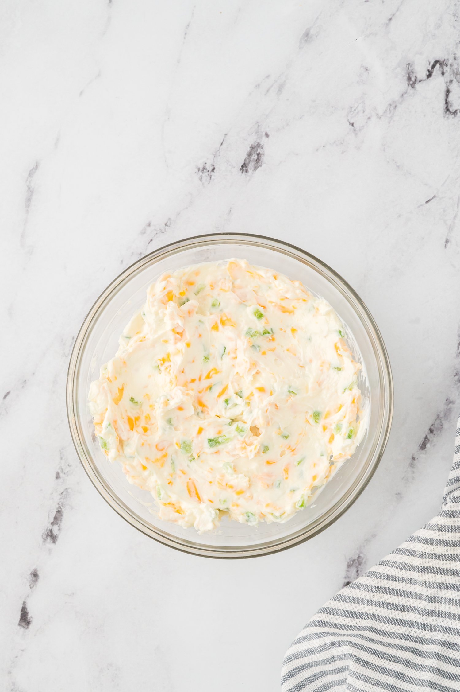 Jalapeno popper filling in glass mixing bowl.