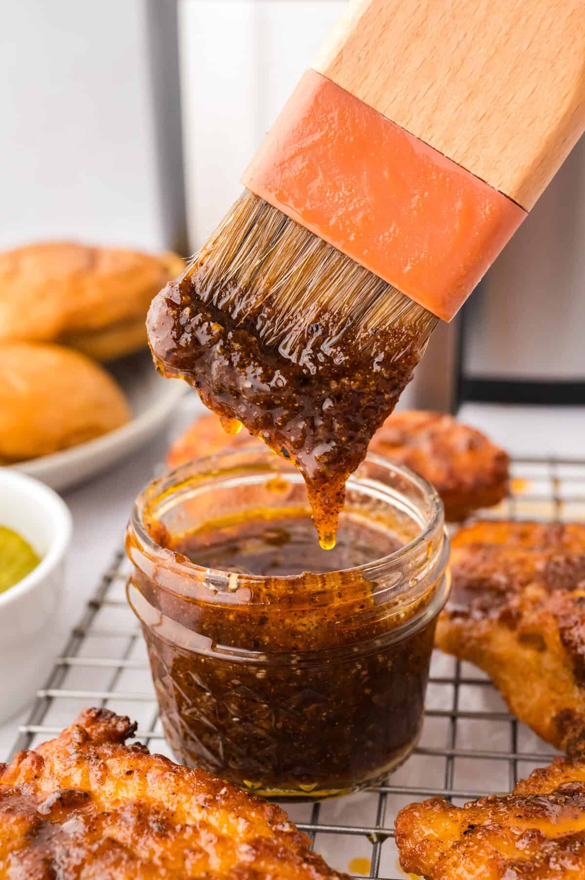 Nashville hot sauce dripping off basting brush.