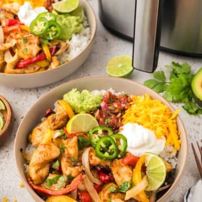 Chicken and vegetables over bowl of rice.