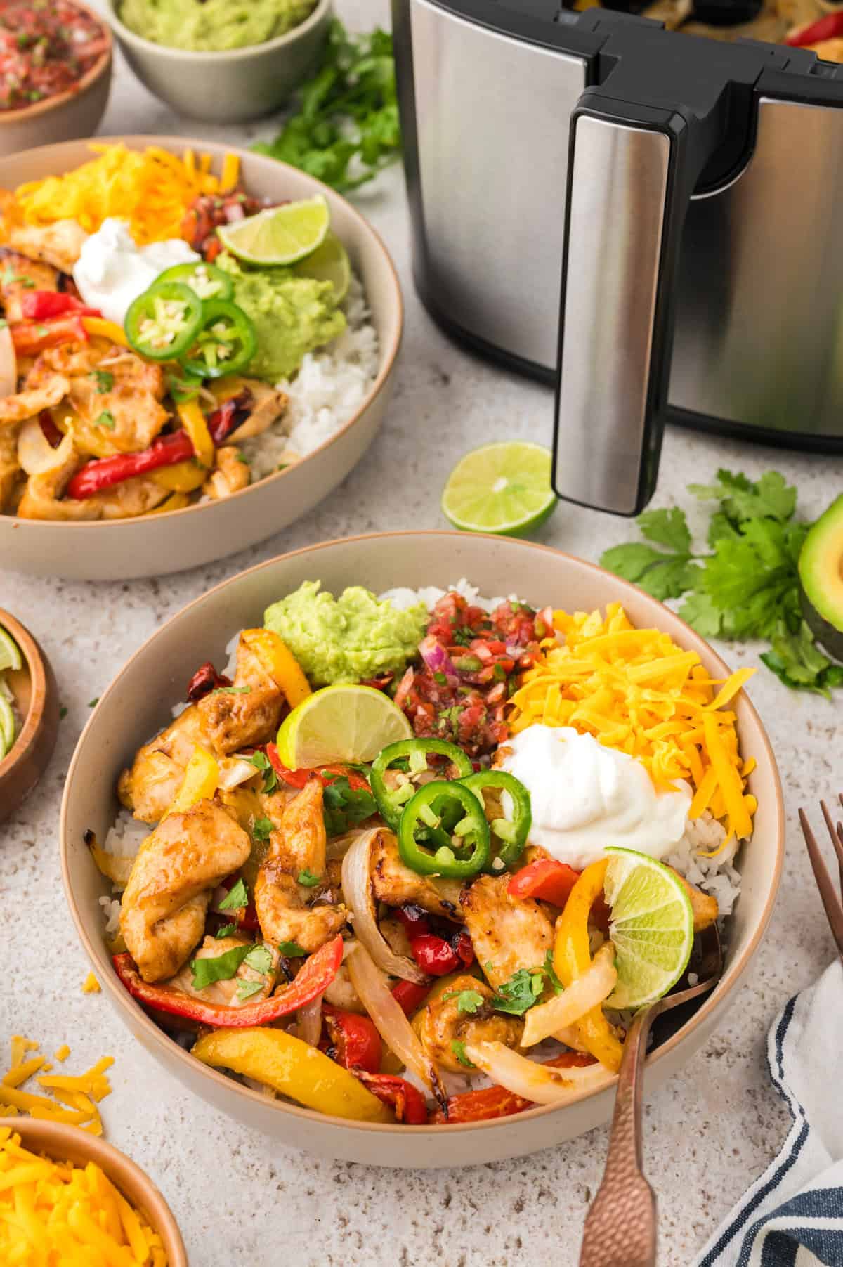 Chicken and vegetables over bowl of rice.