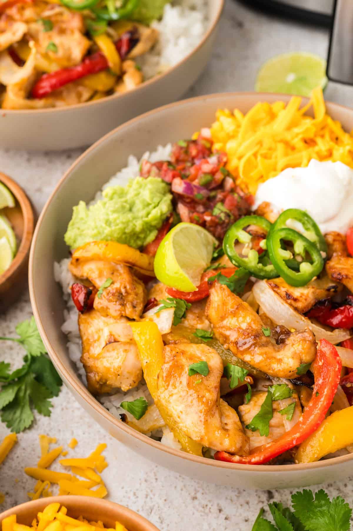 Air fryer chicken fajita bowl on counter.