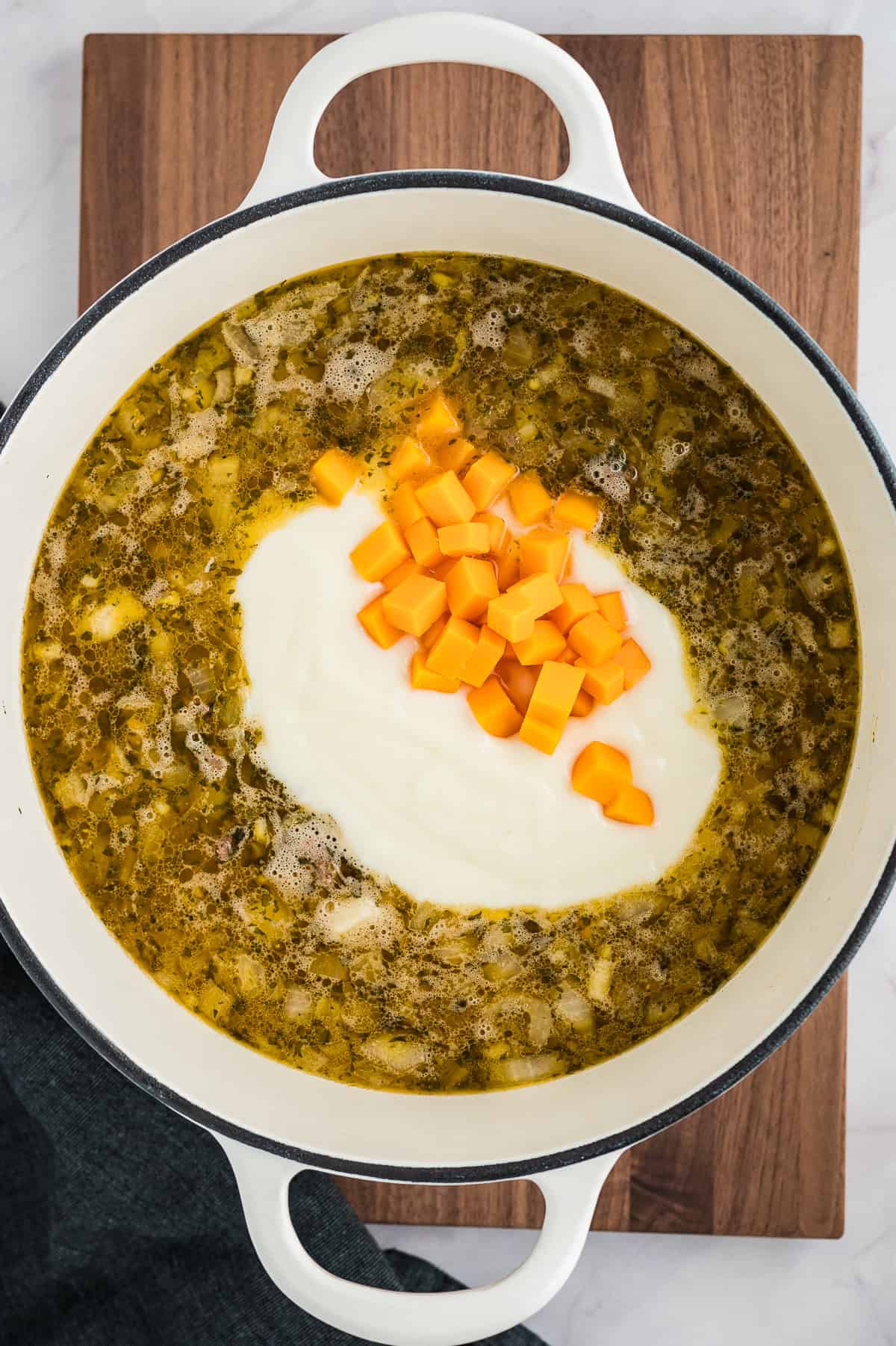 Roux and cheese in pot of soup.