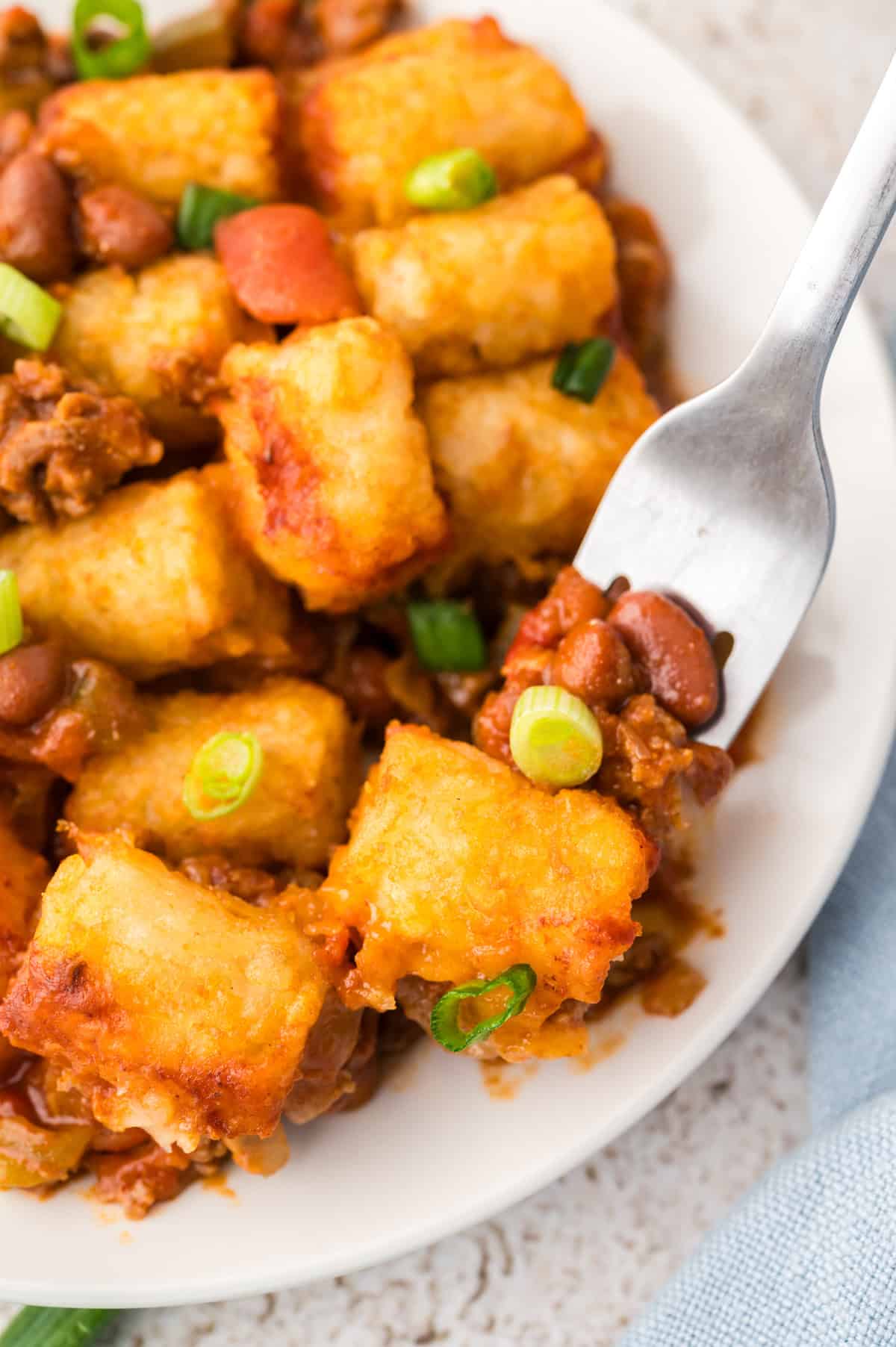 Plate full of chili cheese tater tot casserole with fork.