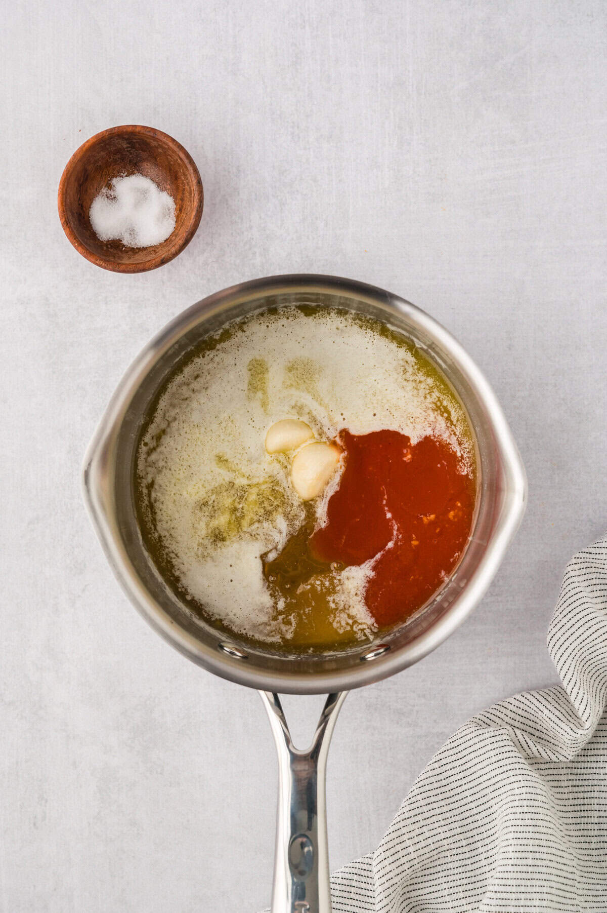 Ingredinets for hot honey sauce in saucepan.